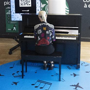 Woman playing the piano in the terminal