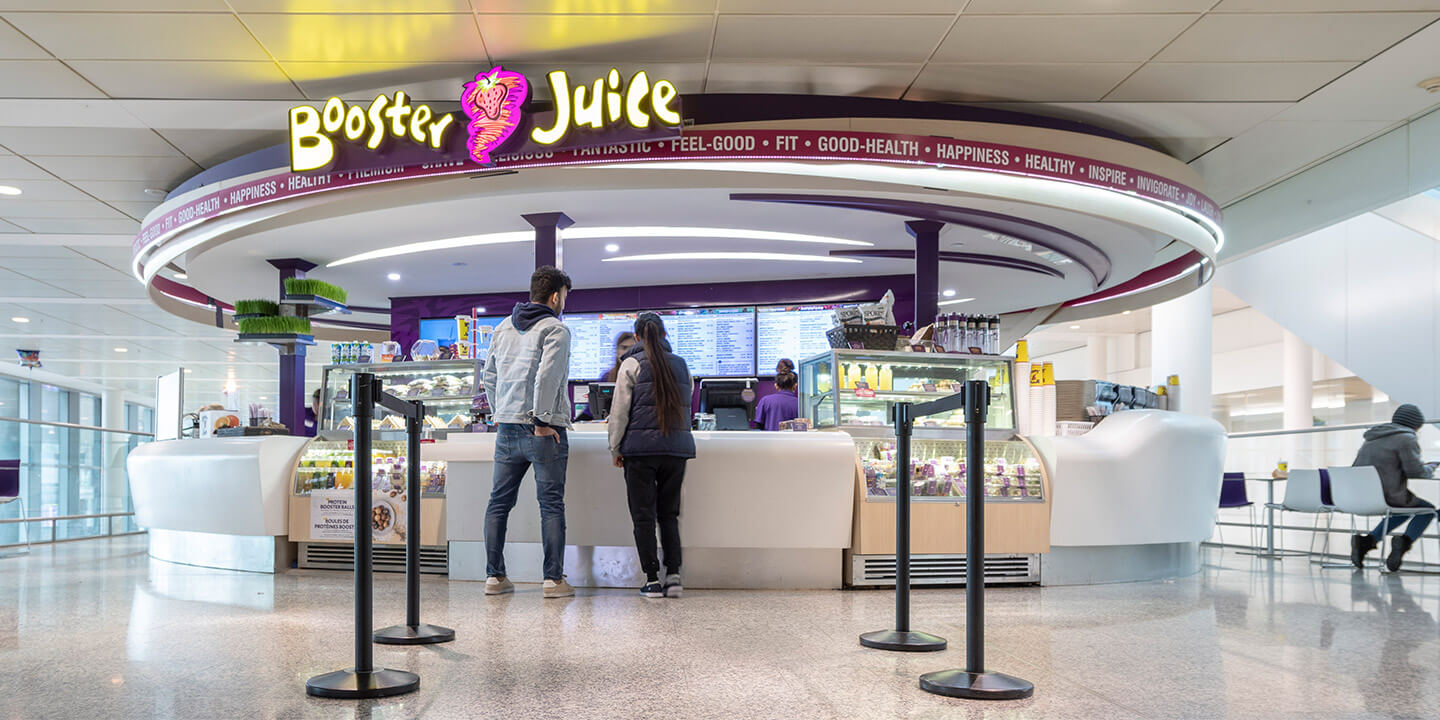 Circular Booster Juice location with two self-service drink fridges