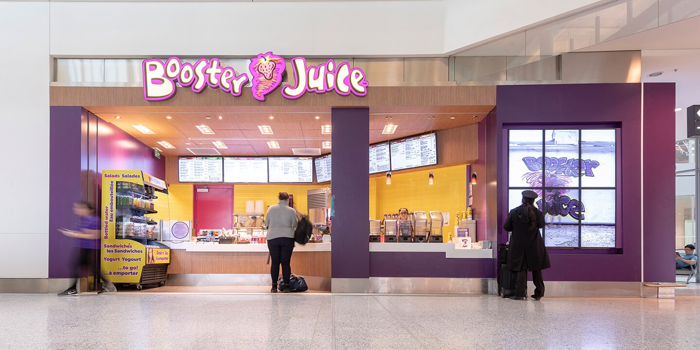 Booster Juice counter with menu and sign.