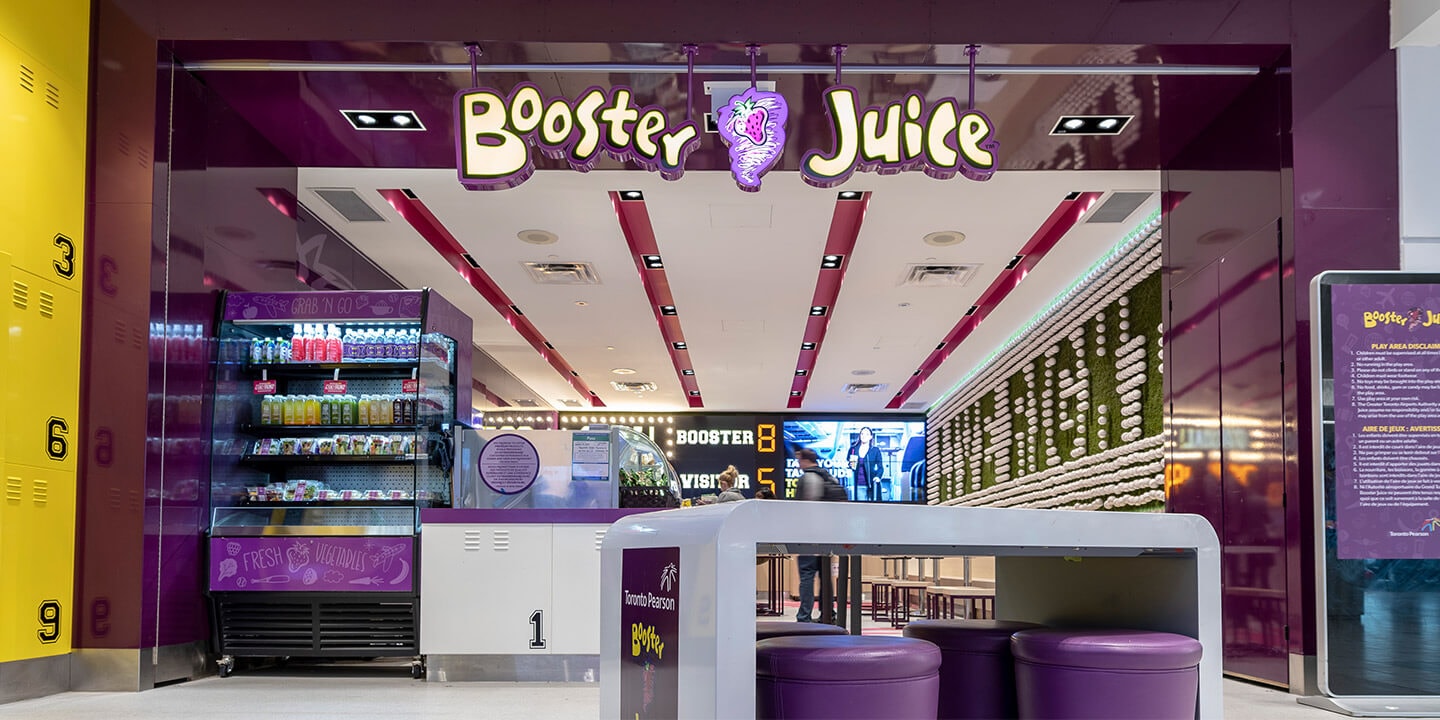 Entrance to Booster Juice restaurant, with ordering counter and self-serve drink fridge
