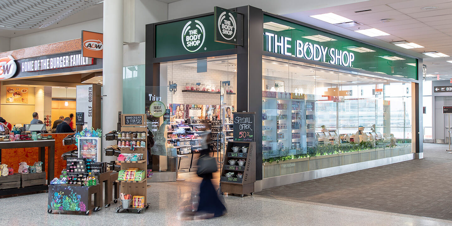 Outside view of The Body Shop store and product displays. 