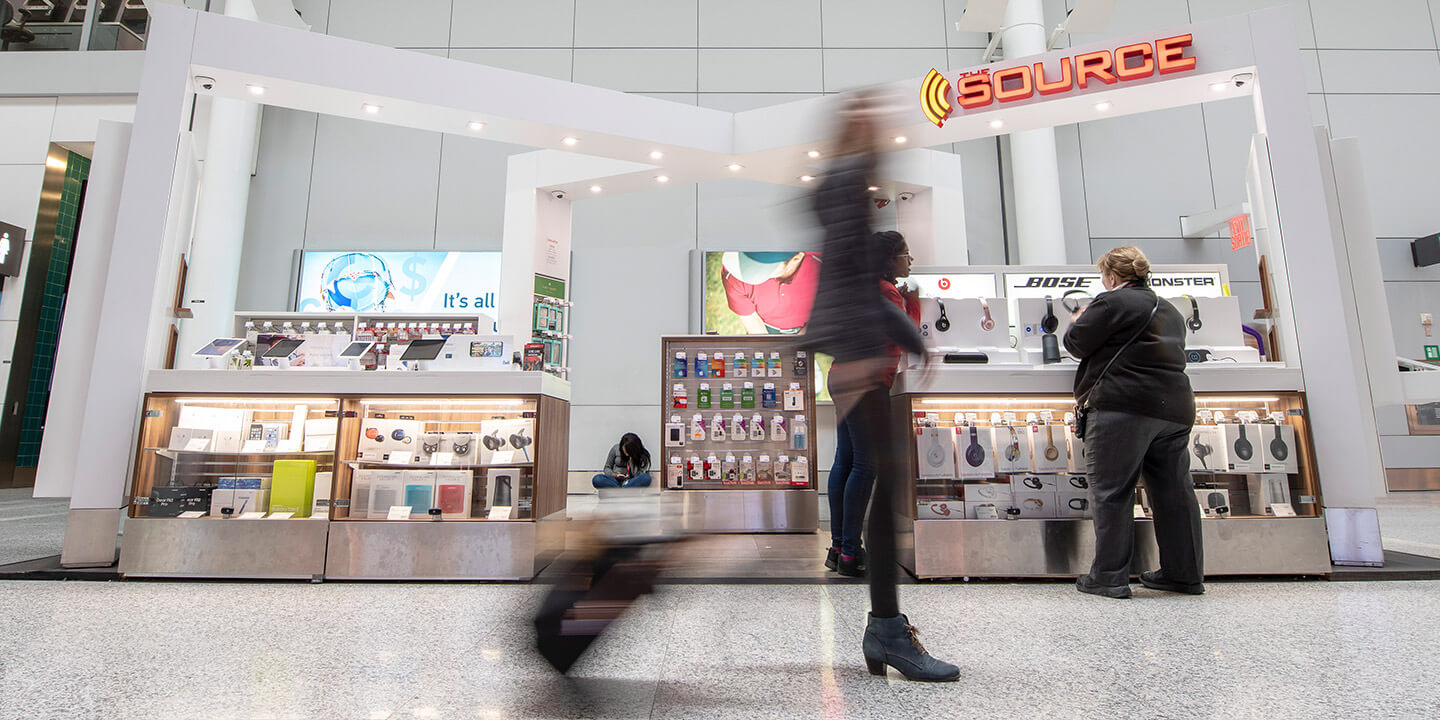 view of source storefront in busy terminal